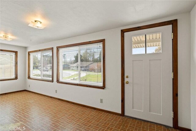 2909 Carlene Pl, Chico, CA 95973 - entryway featuring baseboards, plenty of natural light, and brick patterned flooring