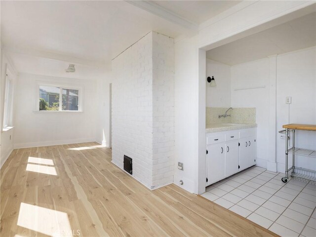 interior space featuring a sink, visible vents, and light wood-type flooring