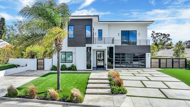 18852 Canyon Crest Dr, Villa Park, CA 92861 - contemporary home with a balcony, stucco siding, concrete driveway, and a gate