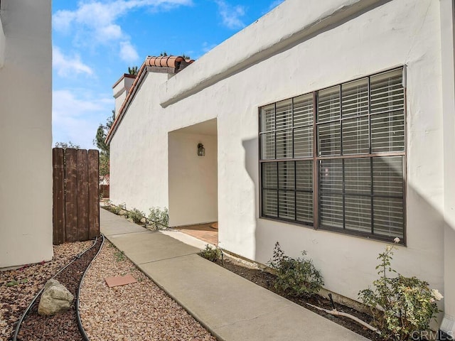 1714 Woodlark Ln, Fallbrook, CA 92028 - view of exterior entry featuring stucco siding and a chimney