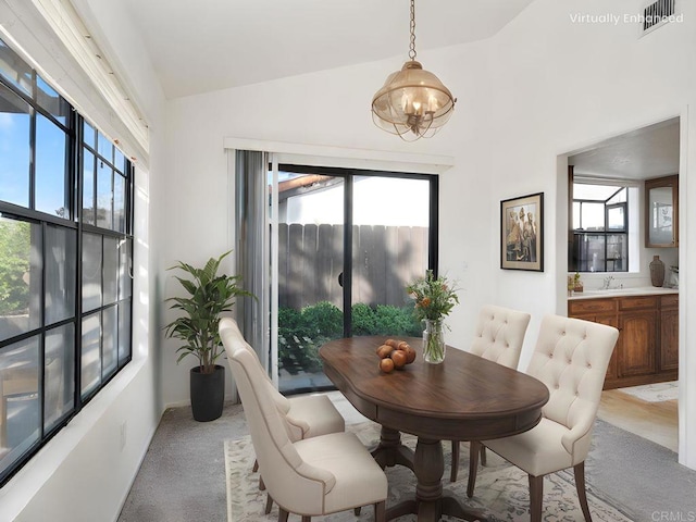 1714 Woodlark Ln, Fallbrook, CA 92028 - dining area featuring a chandelier, light carpet, healthy amount of natural light, and vaulted ceiling