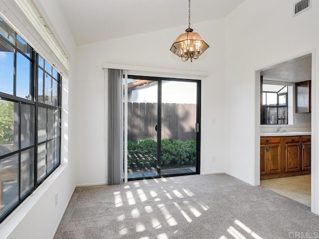 1714 Woodlark Ln, Fallbrook, CA 92028 - unfurnished dining area with a chandelier, healthy amount of natural light, light colored carpet, a sink, and lofted ceiling