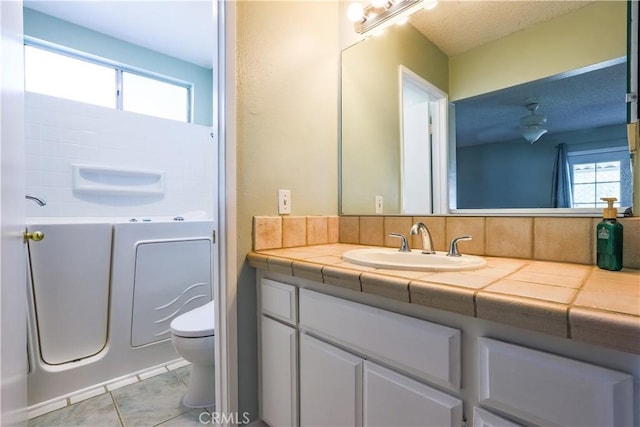 7320 Ramona Ave, Rancho Cucamonga, CA 91730 - bathroom with vanity, plenty of natural light, a tub, and tile patterned flooring