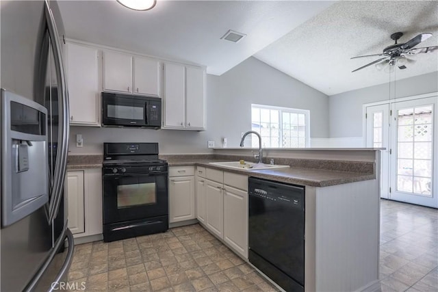 7320 Ramona Ave, Rancho Cucamonga, CA 91730 - kitchen with black appliances, a peninsula, lofted ceiling, dark countertops, and white cabinetry