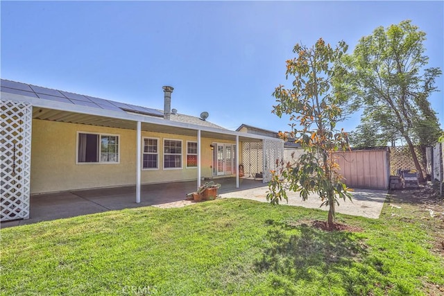 7320 Ramona Ave, Rancho Cucamonga, CA 91730 - back of house with roof mounted solar panels, a patio, and stucco siding