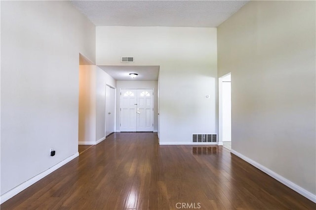 7320 Ramona Ave, Rancho Cucamonga, CA 91730 - foyer with a high ceiling, hardwood / wood-style floors, and baseboards