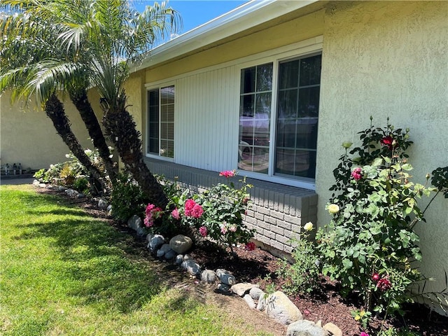 7320 Ramona Ave, Rancho Cucamonga, CA 91730 - view of side of property with a lawn and stucco siding