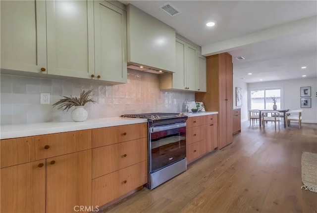 5039 W 135th St, Hawthorne, CA 90250 - kitchen with stainless steel electric stove, light countertops, light wood finished floors, tasteful backsplash, and recessed lighting
