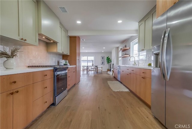 5039 W 135th St, Hawthorne, CA 90250 - kitchen featuring appliances with stainless steel finishes, light countertops, light wood-style floors, backsplash, and recessed lighting