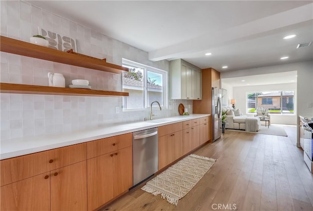 5039 W 135th St, Hawthorne, CA 90250 - kitchen with appliances with stainless steel finishes, light wood-style floors, open floor plan, open shelves, and backsplash