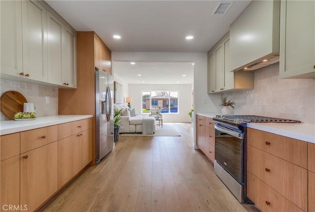 5039 W 135th St, Hawthorne, CA 90250 - kitchen with stainless steel appliances, light countertops, light wood finished floors, open floor plan, and tasteful backsplash