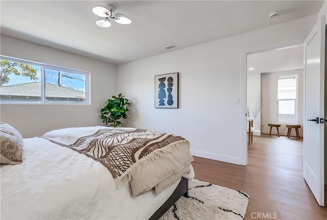 5039 W 135th St, Hawthorne, CA 90250 - bedroom featuring multiple windows, wood finished floors, and a chandelier