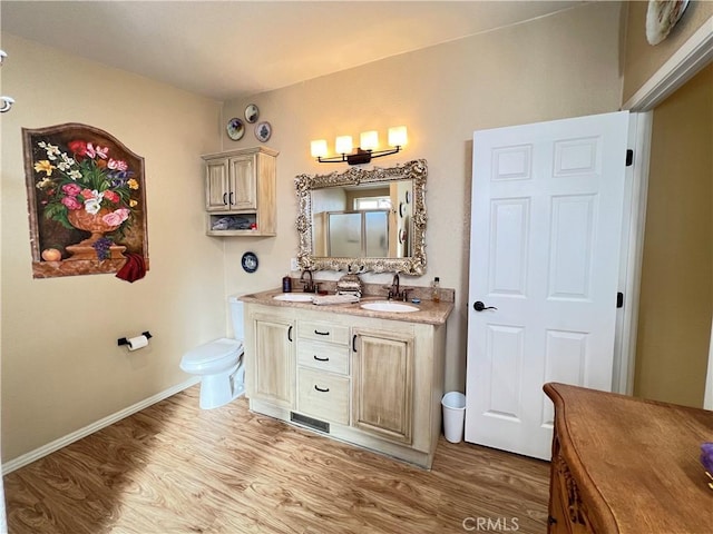 406 Rainbow Rd, Landers, CA 92285 - bathroom with double vanity, wood finished floors, baseboards, and a sink