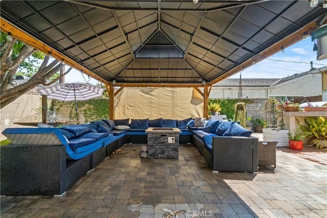 view of patio / terrace featuring a gazebo and an outdoor living space with a fire pit