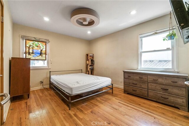 bedroom with recessed lighting, light wood-type flooring, and baseboards