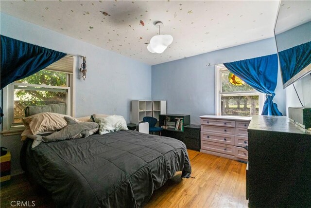 bedroom featuring light wood-style floors