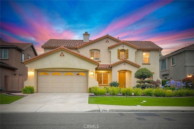 3184 Toopal Dr, Oceanside, CA 92058 - mediterranean / spanish house with a chimney, stucco siding, a garage, a tiled roof, and concrete driveway