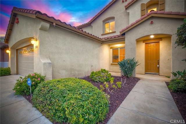 3184 Toopal Dr, Oceanside, CA 92058 - view of front of home featuring an attached garage, a tile roof, stucco siding, and concrete driveway