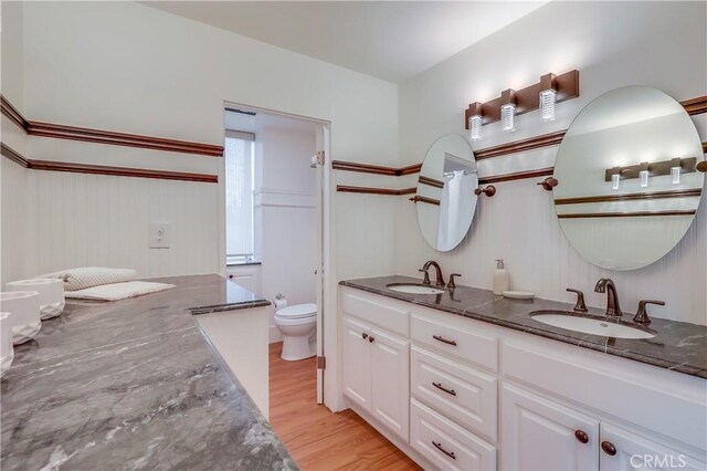 2999 E Ocean Blvd Unit 210, Long Beach, CA 90803 - full bath featuring double vanity, toilet, and wood finished floors