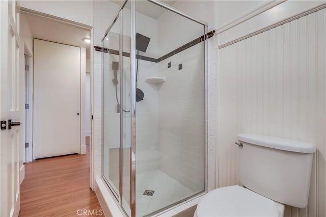 2999 E Ocean Blvd Unit 210, Long Beach, CA 90803 - bathroom featuring toilet, a stall shower, and wood finished floors