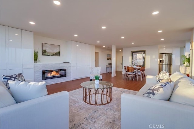 2999 E Ocean Blvd Unit 210, Long Beach, CA 90803 - living room with wood finished floors, a glass covered fireplace, and recessed lighting