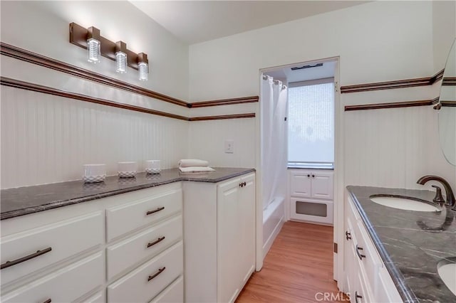 2999 E Ocean Blvd Unit 210, Long Beach, CA 90803 - full bath featuring double vanity, shower / bath combo, and wood finished floors
