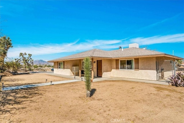 57716 Juarez Dr, Yucca Valley, CA 92284 - rear view of house featuring stucco siding and a mountain view
