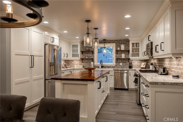 41496 Comstock Ln, Big Bear Lake, CA 92315 - kitchen featuring white cabinetry, high quality appliances, tasteful backsplash, and wooden counters