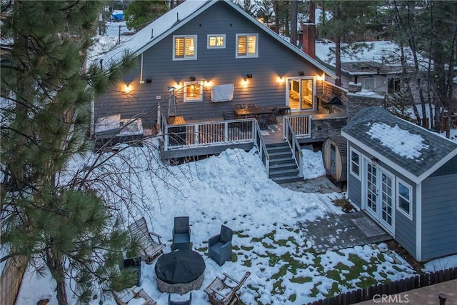 41496 Comstock Ln, Big Bear Lake, CA 92315 - snow covered rear of property with stairway, a fire pit, and a deck
