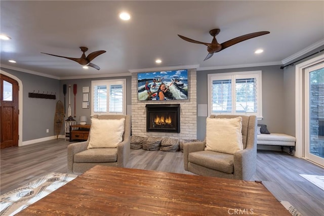 41496 Comstock Ln, Big Bear Lake, CA 92315 - living area with wood finished floors, ceiling fan, a fireplace, and crown molding