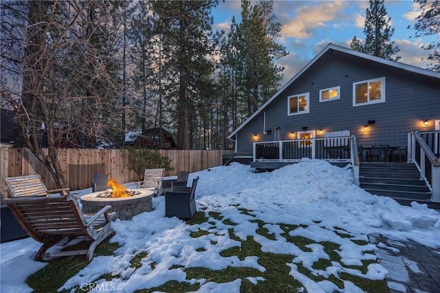 41496 Comstock Ln, Big Bear Lake, CA 92315 - snow covered rear of property with a deck, stairs, a fire pit, and fence