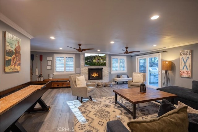 41496 Comstock Ln, Big Bear Lake, CA 92315 - living area with a fireplace, crown molding, a ceiling fan, and light wood-type flooring