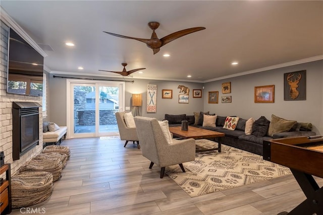 41496 Comstock Ln, Big Bear Lake, CA 92315 - living room featuring ceiling fan, a brick fireplace, wood finished floors, and crown molding