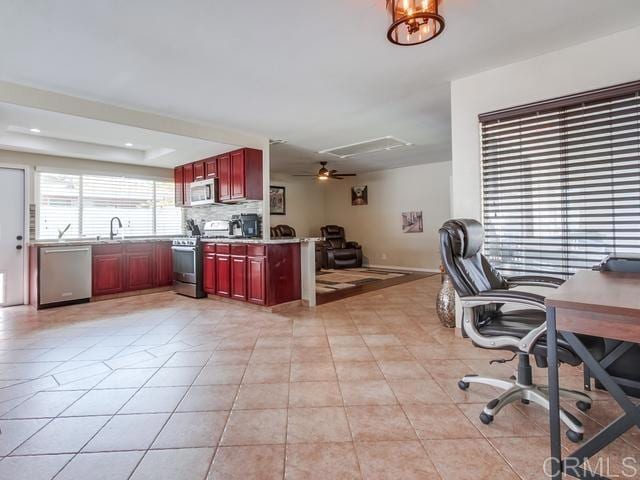 home office featuring light tile patterned floors and a ceiling fan