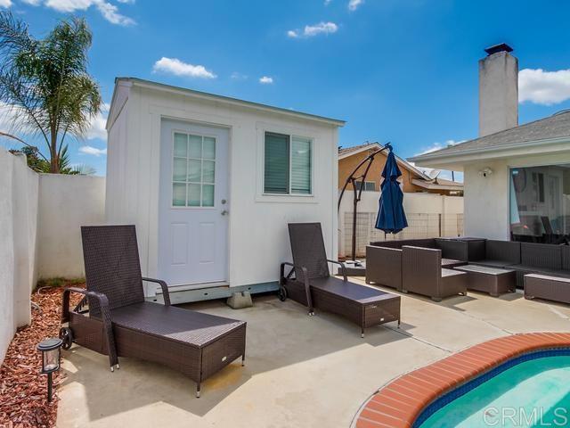 rear view of house featuring an outdoor hangout area, a fenced backyard, and a patio area