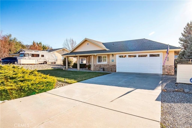 18051 Bold Venture Dr, Tehachapi, CA 93561 - ranch-style home featuring stone siding, a front lawn, concrete driveway, and a garage