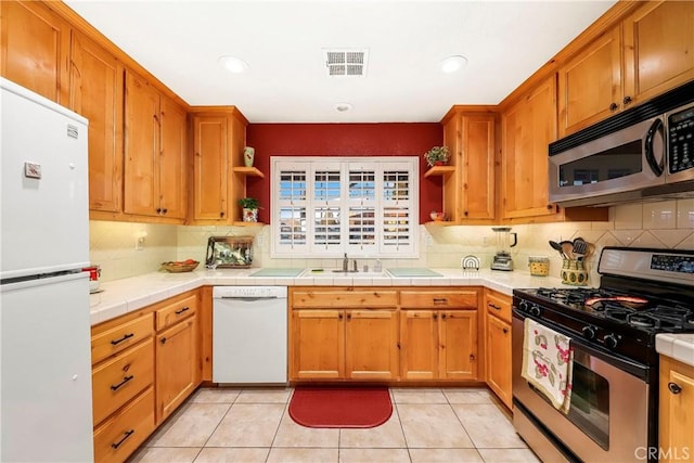 18051 Bold Venture Dr, Tehachapi, CA 93561 - kitchen with open shelves, stainless steel appliances, backsplash, and visible vents