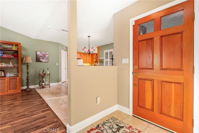 18051 Bold Venture Dr, Tehachapi, CA 93561 - foyer featuring a notable chandelier, baseboards, visible vents, and light tile patterned flooring