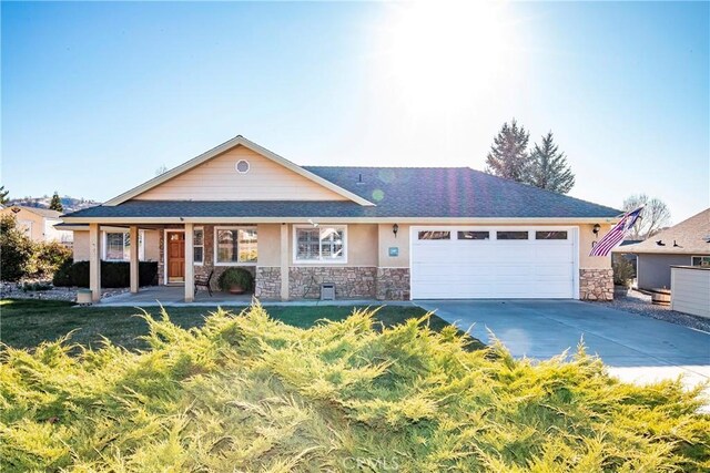 18051 Bold Venture Dr, Tehachapi, CA 93561 - ranch-style home with a garage, stone siding, driveway, and stucco siding