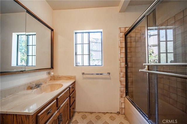 full bath with vanity and bath / shower combo with glass door