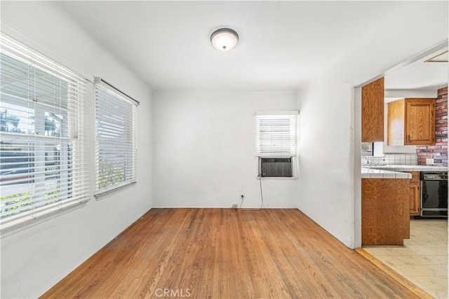 interior space featuring light wood finished floors and cooling unit
