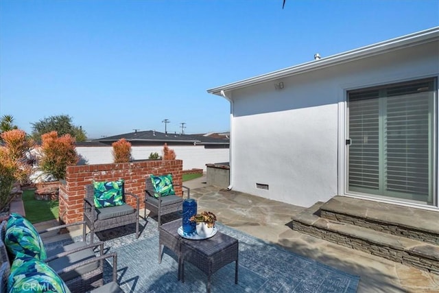 view of patio featuring fence and an outdoor living space