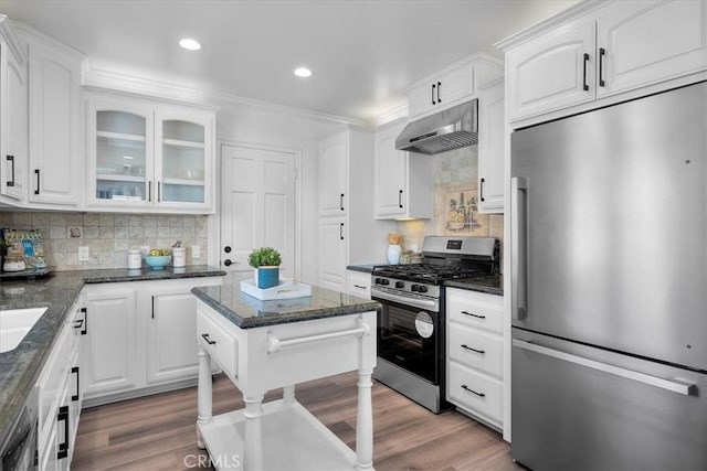 kitchen with high quality fridge, white cabinetry, light wood-style flooring, under cabinet range hood, and stainless steel gas range oven