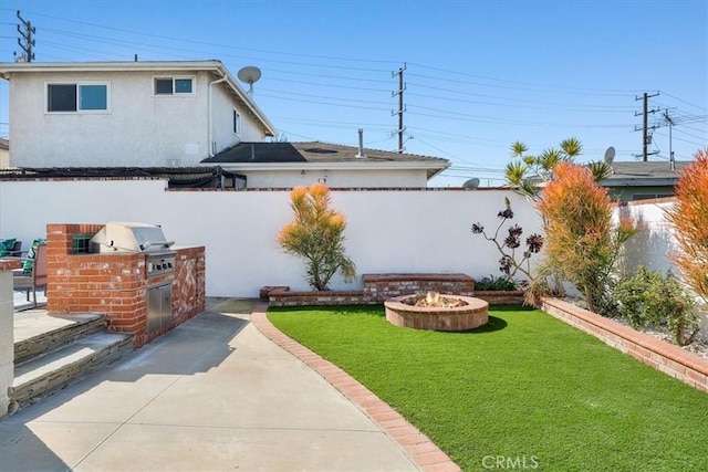 view of yard with a fire pit, a patio area, a fenced backyard, and area for grilling