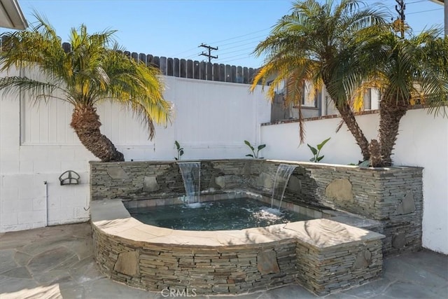 details featuring fence and a hot tub