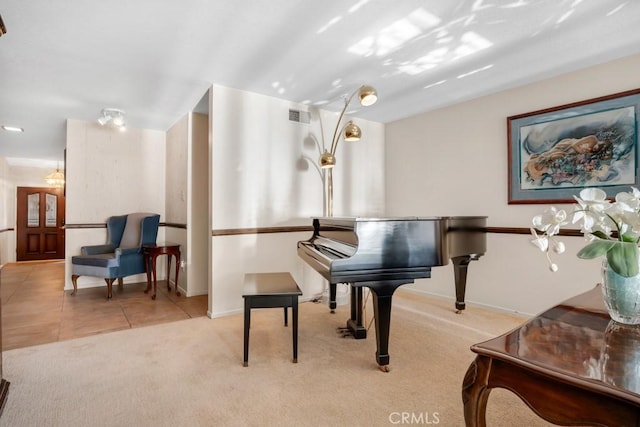 living area featuring visible vents, tile patterned floors, carpet flooring, and baseboards