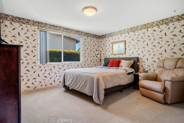 bedroom with wallpapered walls and carpet floors
