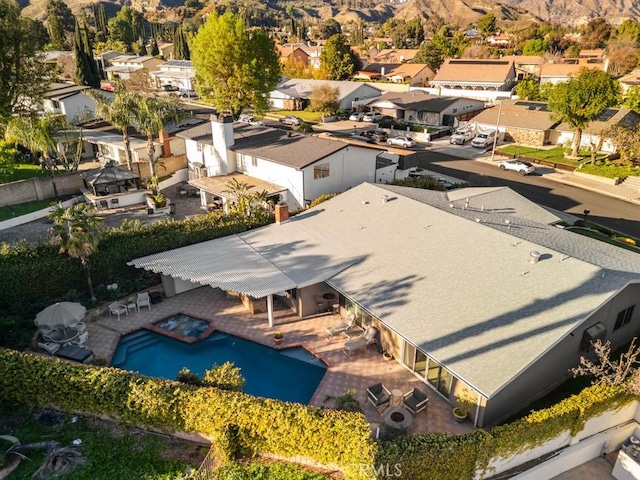 birds eye view of property with a mountain view and a residential view