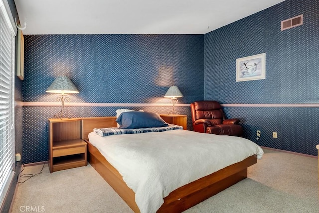bedroom with wallpapered walls, baseboards, visible vents, and carpet floors