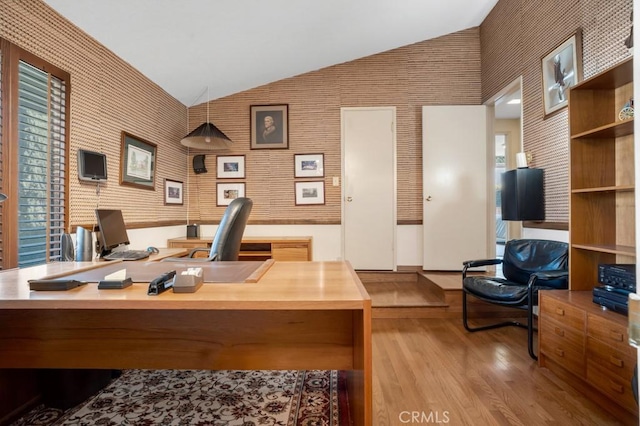 office with wallpapered walls, wood finished floors, and lofted ceiling